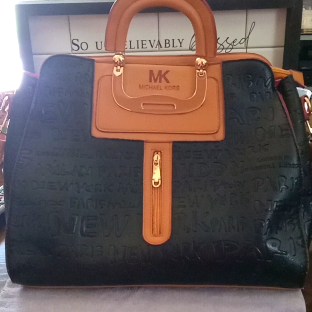 Michael Kors purse. Black & tan in color
